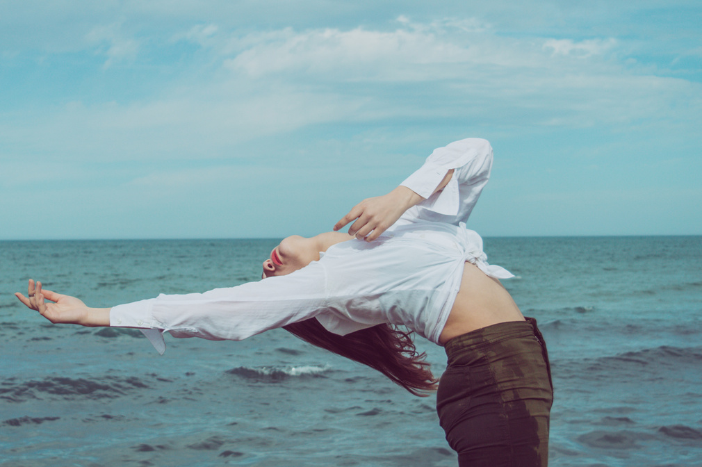 Woman Leaning Backward Near Body of Water